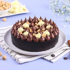 My Dark Chocolate Seasalt Gateau is a light and airy mousse cake with a crunchy Oreo crust. It's topped with more chocolate mousse, eggless meringue, and roasted hazelnuts for a perfect balance of flavors and textures.