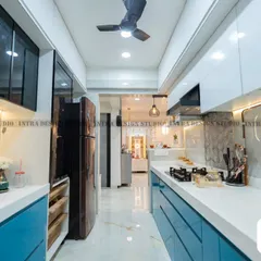 This angle shows how the parallel kitchen layout opens up into the living area. We used sleek, handleless drawers and integrated appliances to maintain a clean and uncluttered feel, maximizing both space and style.