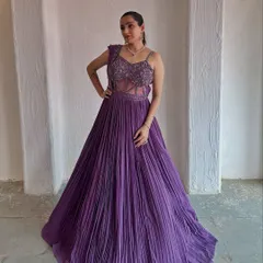 This deep purple gown with a pleated skirt and embellished bodice is a true showstopper. It's a perfect rental for a glamorous evening event.
