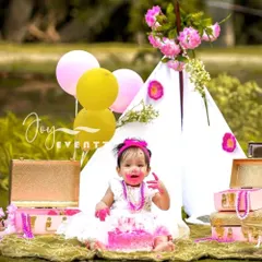 A first birthday is a huge milestone, and we love celebrating it with a fun outdoor cake smash. This session captures the pure, messy joy of the moment against a beautiful, natural backdrop with a tipi tent and festive decorations.
