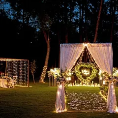 I love creating moments that feel like they're straight out of a fairytale. This outdoor proposal setup in Karjat combines the rustic charm of a forest with the elegance of fairy lights, a heart-shaped floral wreath, and a candlelit dinner for two. It’s a perfect example of how I blend natural beauty with personalized, romantic decor.