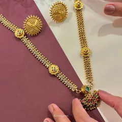 This traditional gold necklace and earring set features intricate beadwork and colorful enamel details. It is a labor of love, designed to last through the ages and be part of your family's story.