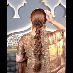 This angle showcases the beautiful shape and structure of the intricate braid, a testament to detailed hairstyling for a memorable wedding look.