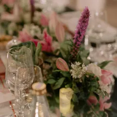 The finale dinner for K+G was planned to perfection. This long table setting features mirrored surfaces reflecting hanging floral arrangements and chandeliers, creating an immersive and glamorous dining experience.