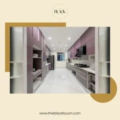 A stunning parallel kitchen with high-gloss lavender cabinets and a sleek black refrigerator. The design is modern, spacious, and highly functional.