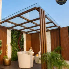 We transform urban rooftops into serene escapes. This modern glass roof pergola creates a bright, protected space that perfectly complements the clean lines of the home, a vertical garden, and minimalist furniture, proving that luxury can exist anywhere.