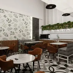 Here you can see the interplay of different textures in the cafe design. The exposed brick-style wall, the leafy wallpaper, and the smooth marble-top tables create a rich, layered look that is both modern and comfortable.