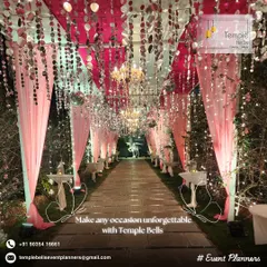 A magical walkway designed for an evening reception, creating an unforgettable entrance for guests. We used flowing pink drapes, hanging crystals, and shimmering discs to catch the light from the chandeliers and fairy lights.