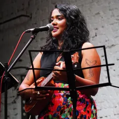 Performing solo with my ukulele at an intimate event. This setup is all about creating a personal connection through raw, honest music.