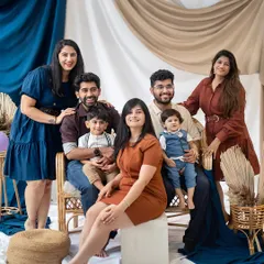 This portrait focuses on the younger generation of the family, highlighting the close bonds between siblings and cousins in a warm, earthy-toned studio setup.