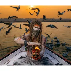 An Aghori sadhu performs a ritual with a skull and fire while floating on the Ganga at sunset. This is one of the most intense and visually striking spiritual practices I've ever witnessed.