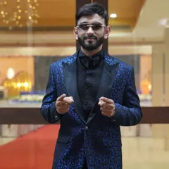 This photo, taken at a hotel before an event, shows another angle of the custom blue tuxedo. I'm always camera-ready, whether on the red carpet or interacting with guests.