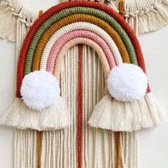 A close-up of the rainbow on the "Live, Love, Laugh" wall hanging. The earthy, warm colors were chosen specifically by the client to match their home decor.