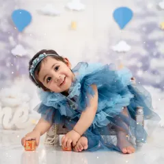 Playful and sweet, this little one is all smiles during her first birthday photoshoot, surrounded by dreamy props.