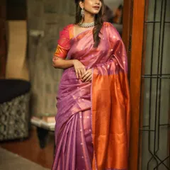 This dual-toned linen silk saree in purple and orange is both vibrant and comfortable. It’s a perfect example of how you can look festive and feel completely at ease.