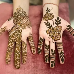Two different styles for guests. One hand features a delicate Arabic floral vine, while the other has a more detailed Indo-Arabic design.