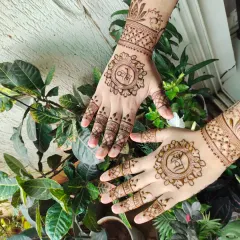 A simple and elegant floral design, featuring the couple's initials inside a beautiful mandala on the back of each hand.