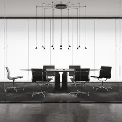 The Filomena system by Karman is configured as a spider-like chandelier over a conference table. The minimalist black cones provide precise, downward-focused light, making it a perfect solution for modern office and commercial spaces.
