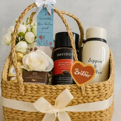Here’s the perfect Rakhi gift for your favorite brother. This thoughtful basket includes a "Sippin' & Chillin'" stainless steel bottle, rich Davidoff coffee, Ferrero Rocher chocolates, and grooming essentials from The Man Company, all ready to make his day.