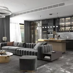 This design for a corporate lounge or executive suite living area combines comfort and luxury. The space features a plush sectional sofa, a modern kitchen bar, and sophisticated materials like polished marble floors and dark, glossy cabinetry for a high-end residential feel.