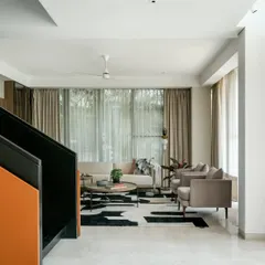 In the living room of Villa 93, we created a sanctuary of calm with a neutral color palette and abundant natural light. The design marries modern furniture with a bold, graphic rug, creating a space that is both sophisticated for entertaining and comfortable for quiet family moments.