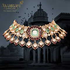 A breathtaking choker necklace featuring large polki stones, surrounded by emeralds and rubies. This is a true statement piece, reflecting the royal heritage of Indian jewellery design.