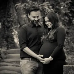 This black and white photo focuses on the couple's hands cradling the baby bump, a simple and powerful image of their shared love and anticipation.