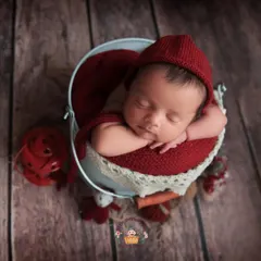 This pose, with baby's head resting gently on their hands in a bucket, is a classic for a reason. It shows off their tiny profile and peaceful expression in such an adorable way.
