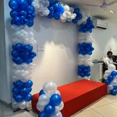 The balloon arch in TVS brand colors, blue and white, creating a photo-ready spot for the new product.
