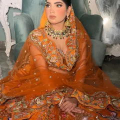 My orange fall bride. This look is for the bride who wants something different, pairing a vibrant orange lehenga with a multi-colored Kundan necklace for an enchanting look.
