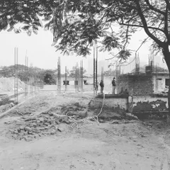 A site visit during the early stages of construction. Here, the foundation is being laid and the building's initial footprint is taking shape.