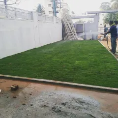 During: Our team member waters the newly installed lawn. Consistent watering is essential in the early stages to help the grass take root and thrive.