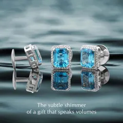 The subtle shimmer of a gift that speaks volumes. These custom cufflinks feature stunning emerald-cut blue topaz stones surrounded by a halo of diamonds. They are a perfect way to add a touch of colour and sophistication to a formal look.