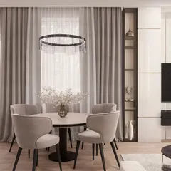 This angle highlights the thoughtful storage solutions that tie the space together. The tall, white cabinetry on the right provides ample storage while blending into the wall, and the open glass shelving adds a decorative touch. The elegant ring chandelier serves as a centerpiece for the dining area.