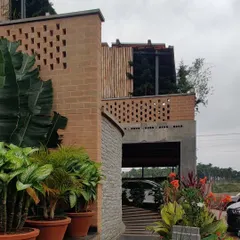 The Sunyata Hotel, where the architecture is designed to merge with the landscape. Here, brick jali walls and lush planters define the entrance.