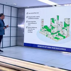 Here I am explaining the core benefits of high-rise buildings during a masterclass. I believe vertical development is crucial for modern cities. It allows us to integrate offices, retail, and homes in one place, which reduces travel time, lowers pollution, and creates space for vital green areas that improve community well-being.