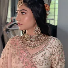 A side profile of Rashi's wedding hairstyle, showing the placement of the fresh flowers.
