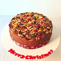 My traditional Christmas plum cake is a labor of love. It's incredibly rich and dense, packed with rum-soaked fruits and topped with a generous layer of toasted almonds and dried berries for a festive finish.