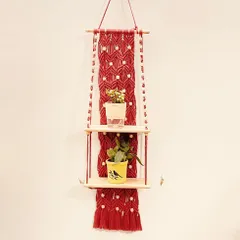 Here is the same two-tier red shelf design, styled with small plants to show how it can bring life to a plain wall. The double shelves offer ample space for a collection of small succulents or decorative objects.