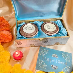 A luxurious Diwali gift box with a beautiful blue satin lining. This chest contains two jars of assorted chocolates and flavoured almonds, perfect for the festive season.