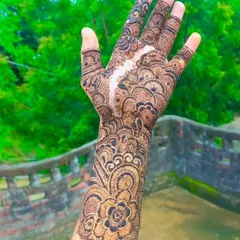 A classic full-hand design that extends up the wrist, featuring a mix of floral, paisley, and geometric elements.