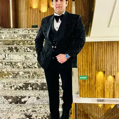 Our client looks absolutely stunning in this fully embellished black tuxedo. The intricate beadwork covers the entire jacket, creating a luxurious and celebratory look for a formal wedding event.