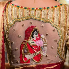 The back of this blouse is a canvas, featuring a stunning hand-embroidered figure of a bride in a red veil, making this a truly personal and unforgettable piece.