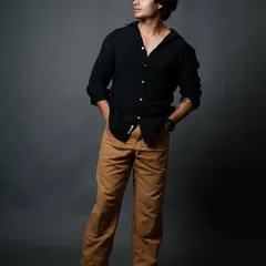 A classic relaxed pose with hands in pockets, showcasing a confident and approachable look for a male model's portfolio.