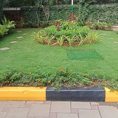 A completed landscaping project at Sobha Carnation. We created a central plant bed with a mix of flowering shrubs and laid fresh turf with stepping stones, all framed by a neat black and yellow curb.