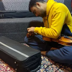 A musician tuning his violin during our recording session. The attention to detail and dedication of my collaborators is always inspiring.