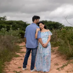 A serene outdoor maternity photo of a couple on a country path. This shot captures a quiet, reflective moment together in nature as they look forward to their new chapter.