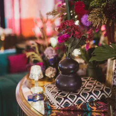Another detail from the sangeet centerpiece, highlighting the texture of the vase and the custom-printed books used as decorative risers.