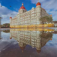 This is one of my favorite shots, where the monsoon rain turns the streets into a perfect mirror for the iconic Taj Mahal Palace. It feels like capturing a dream, a perfect reflection of Mumbai's heritage and beauty.