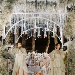 Vedic singers performing at a ceremony in Udaipur. The serene music and ethereal floral mandap create a sacred space for the couple's vows.
